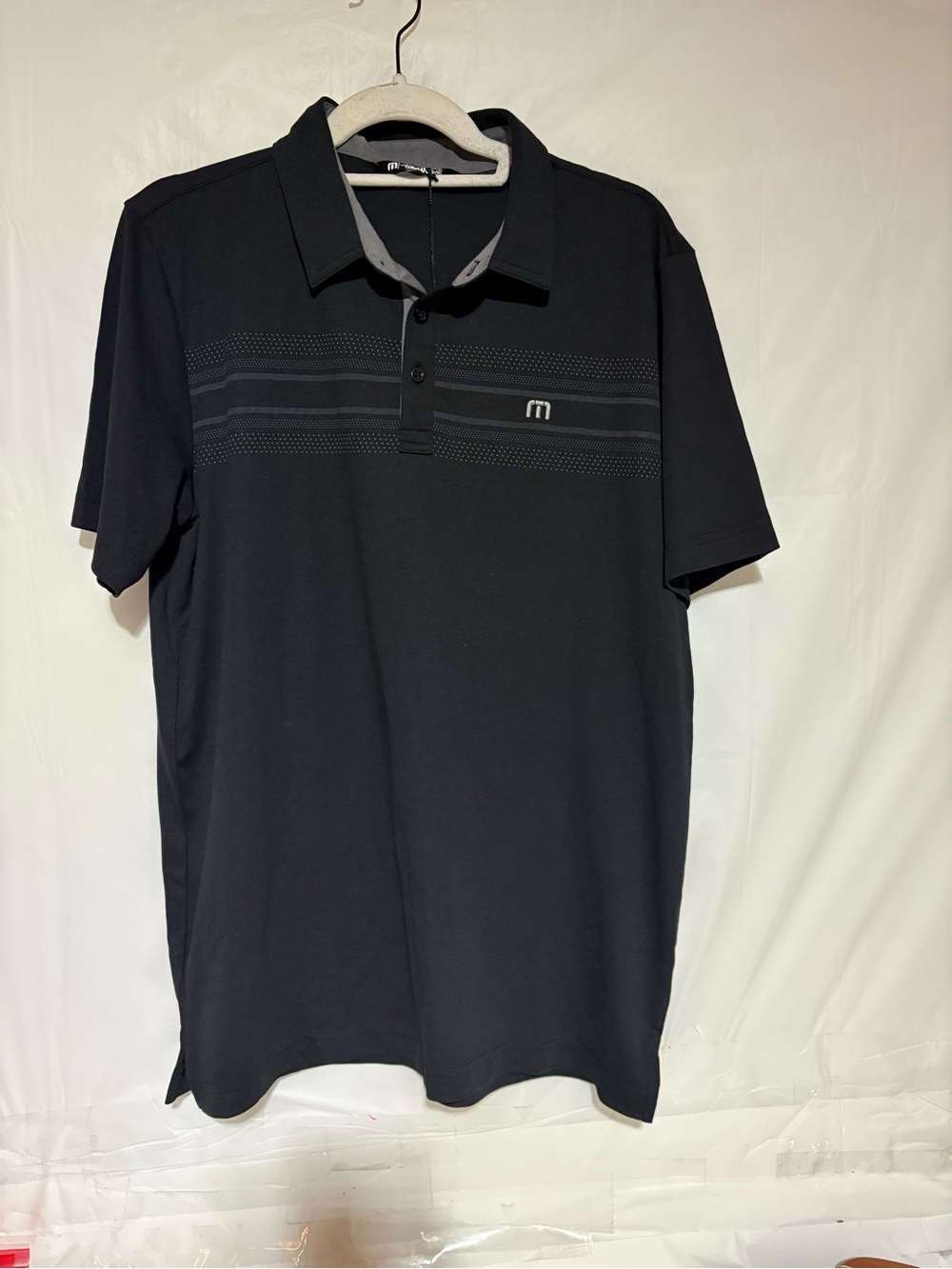 Travis Mathew Black Polo with Subtle Tone-on-Tone Chest Stripes
